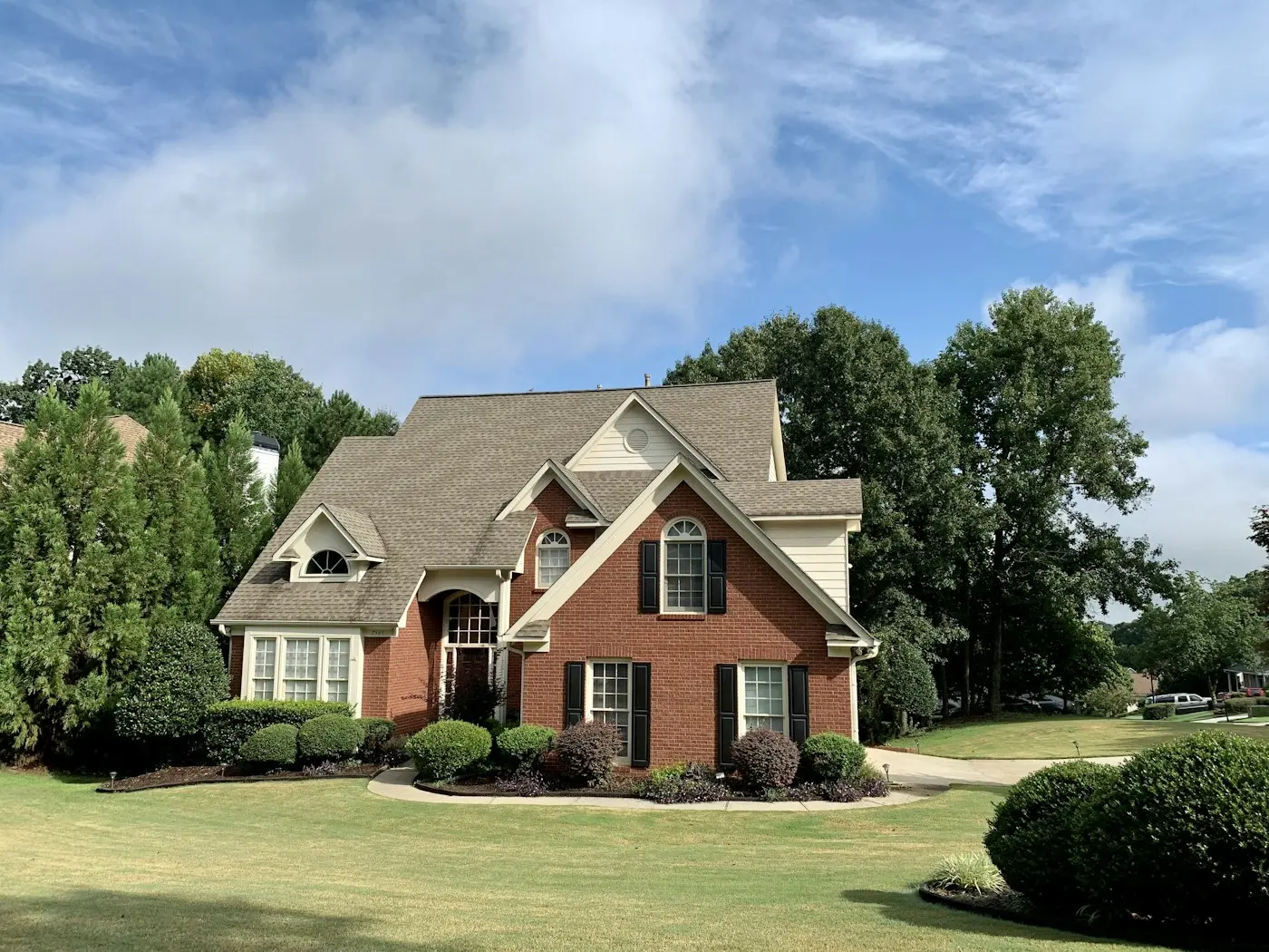 Brick suburban house with a landscaped front yard